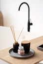 Spa treatment composition on wooden table, diffuser candles and pink sea salt for meditation and relaxation. Soft selective focus Royalty Free Stock Photo