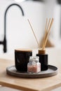 Spa treatment composition on wooden table, diffuser candles and pink sea salt for meditation and relaxation. Soft selective focus Royalty Free Stock Photo