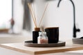 Spa treatment composition on wooden table, diffuser candles and pink sea salt for meditation and relaxation. Soft selective focus Royalty Free Stock Photo