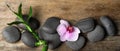 Spa treatment. Flat lay composition with stones, bamboo and orchid flower on wooden table. Banner design Royalty Free Stock Photo