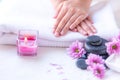 Spa treatment and product for female feet and manicure nails spa with pink flower and rock stone, copy space, select focus,