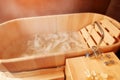 Spa treatment in the salon for relieving fatigue in a traditional folk style in a wooden bath with hydro massage Royalty Free Stock Photo
