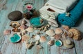 Colored crystals of sea salt, towels, burning floating candles, shells and corals on a light blue wooden background. Royalty Free Stock Photo