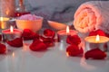 Spa treatment set with scented oil, salt, candles, rose petals and flowers Royalty Free Stock Photo