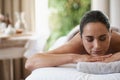 Spa, treatment and zen woman on massage table, salon and beauty therapist in wellness centre. Peaceful, smile and Royalty Free Stock Photo