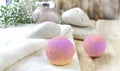 Spa or wellness bodycare setting. Still life image with bath bombs, stones, scrub, towel on wooden background. Royalty Free Stock Photo