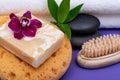 Spa Wellness Concept. Foam Sea Sponge, Almond Goat`s milk Soap, Natural Bristle Wooden Brush, Basalt Stones, Bamboo and Orchid