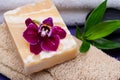 Spa Wellness Concept. Natural Loofah Sponge, Almond Goat`s milk Soap, White Towels, Basalt Stones, Bamboo and Orchid Flower Royalty Free Stock Photo