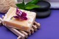 Spa Wellness Concept. Natural Loofah Sponge, Almond Goat`s milk Soap, White Towels, Basalt Stones, Bamboo and Orchid Flower Royalty Free Stock Photo