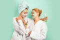 Spa and wellness. Girls friends sisters making clay facial mask. Anti age mask. Stay beautiful. Skin care for all ages Royalty Free Stock Photo