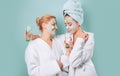 Spa and wellness. Girls friends sisters making clay facial mask. Anti age mask. Stay beautiful. Skin care for all ages Royalty Free Stock Photo