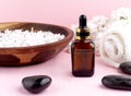 Spa and wellness with perfumed white lilac flowers water in wooden bowl and terry towel and bottle aromatherapy and black stones, Royalty Free Stock Photo