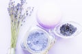 Spa and wellness setting with lavender flowers, sea salt, oil in a bottle, aroma candle on wooden white background Royalty Free Stock Photo