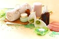 Spa and wellness setting with natural soap, candles and towel. natural wooden background . green color set.