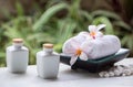 Spa and wellness setting with natural soap, stones and towel on the green background .