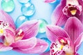 Spa and wellness setting with orchid flower, glass drops on wooden blue background closeup top view Royalty Free Stock Photo