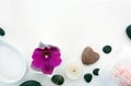 Spa setting with pink orchids, black stones and bath salts on wood background. Royalty Free Stock Photo