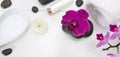 Spa setting with pink orchids, black stones and bath salts on white wood . Royalty Free Stock Photo