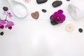 Spa setting with pink orchids, black stones and bath salts on wood background. Royalty Free Stock Photo