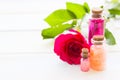 Spa and wellness setting with rose flower, sea salt, oil in a bottle on wooden white background Royalty Free Stock Photo