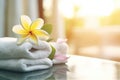 Spa, wellness setting, towels, frangipani flowers. Royalty Free Stock Photo