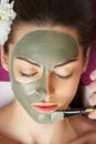 Spa Woman applying Facial clay Mask. Beauty Treatments. Close-up portrait of beautiful girl applying facial mask.Cosmetology. Body Royalty Free Stock Photo