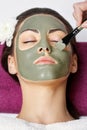 Spa Woman applying Facial clay Mask. Beauty Treatments. Close-up Royalty Free Stock Photo