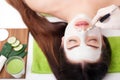 Spa Woman applying Facial cleansing Mask. Beauty Treatments. Clay mask Royalty Free Stock Photo