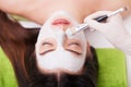 Spa Woman applying Facial cleansing Mask. Beauty Treatments. Clay mask Royalty Free Stock Photo