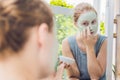 Spa Woman applying Facial green clay Mask. Beauty Treatments. Cl Royalty Free Stock Photo