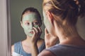 Spa Woman applying Facial green clay Mask. Beauty Treatments. Cl Royalty Free Stock Photo