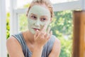 Spa Woman applying Facial green clay Mask. Beauty Treatments. Cl Royalty Free Stock Photo