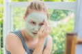 Spa Woman applying Facial green clay Mask. Beauty Treatments. Cl Royalty Free Stock Photo