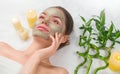 Spa Woman applying Facial green clay Mask. Beauty Treatments. Close-up portrait of beautiful girl in spa salon. Dayspa Royalty Free Stock Photo