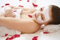 Spa Woman. Beautiful Woman Relaxes on Bed . Royalty Free Stock Photo