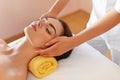 Spa Woman. Beautiful Young Woman Getting a Face Treatment at Beauty Salon. Face Massage Royalty Free Stock Photo