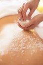 Spa Woman. Brunette Getting a Salt Scrub Beauty Treatment in the Royalty Free Stock Photo