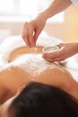 Spa Woman. Brunette Getting a Salt Scrub Beauty Treatment in the Royalty Free Stock Photo