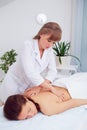 Spa woman. Female enjoying relaxing back massage in cosmetology spa centre. Body care, skin care, wellness, wellbeing Royalty Free Stock Photo