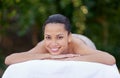 Spa, woman and portrait on massage bed with smile for wellness, zen and beauty treatment for body care. Person, relax Royalty Free Stock Photo