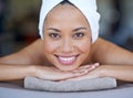 Spa, woman and portrait on massage bed with smile for wellness, zen and beauty treatment for body care. Person, relax Royalty Free Stock Photo