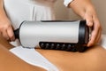 Spa worker makes stomach massage for woman with special device Royalty Free Stock Photo