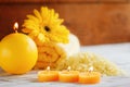 Spa yellow products setting. Sea salt ,towel and candles on dark wooden background Royalty Free Stock Photo