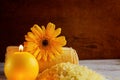 Spa yellow products setting. Sea salt ,towel and candles on dark wooden background Royalty Free Stock Photo