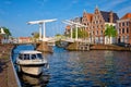 Spaarne river with boat and Gravestenenbrug bridge in Haarlem, Netherlands Royalty Free Stock Photo