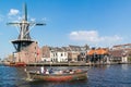 Spaarne river with canal boat and windmill, Haarlem, Netherlands