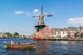 Spaarne river with canal boat and windmill, Haarlem, Netherlands Royalty Free Stock Photo