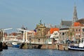 The Spaarne riverside, with Teylers Museum, Gravestenenbrug bridge and the clock tower of St Bavokerk Church in the background Royalty Free Stock Photo