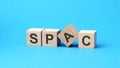 spac - text on wooden blocks, business concept, blue background