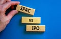 SPAC vs IPO symbol. Blocks with words `SPAC, special purpose acquisition company` and `IPO, initial public offering` on blue